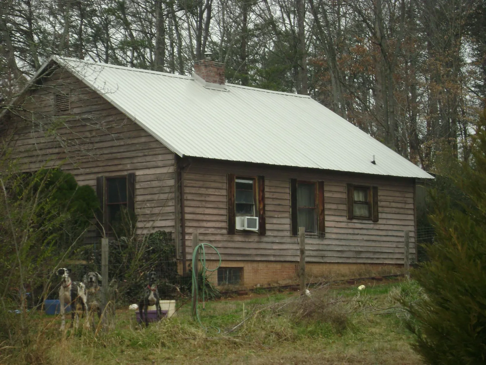 White metal roof on an old wood sided farmhouse, from a Metal Roof Installation job in Hampton